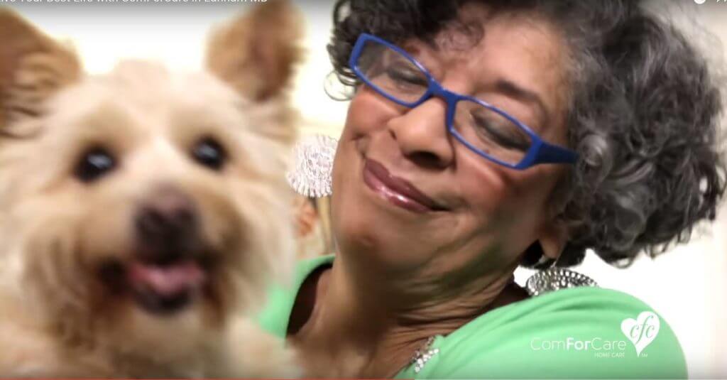 An older woman happy with her dog
