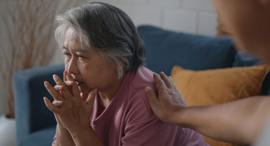 An elderly parent struggles to remember as her child comforts her.