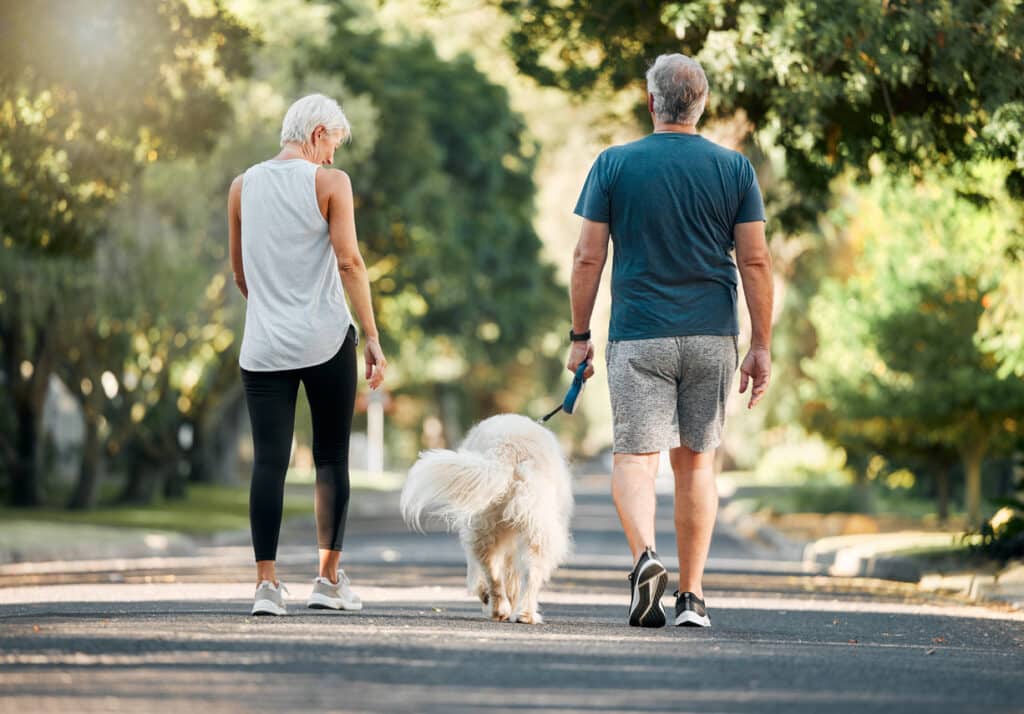 Senior walking outdoors in New Braunfels park for daily physical activity