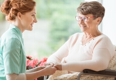 Young woman holding hands of a senior woman in Waukesha County