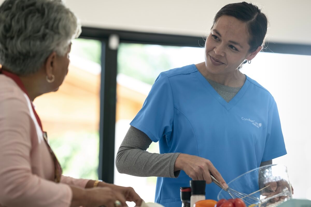 ComForCare Caregiver helping meal prep