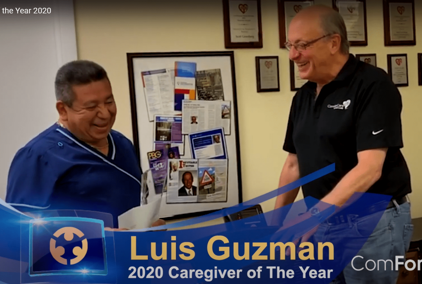 A photo of Luis Guzman being presented with an award for being 2020 caregiver of the year.