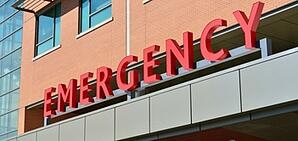 The sign for "Emergency" on the outside of a hospital.