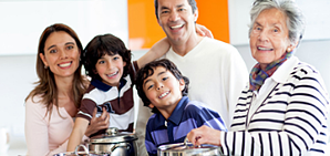 Three generations of a family cooking together.