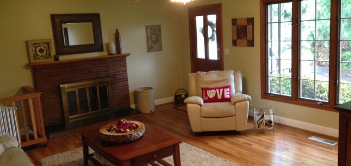 A photo of a living room with a fireplace.