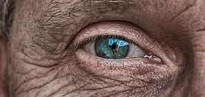 Close up of a blue eye on an older person.